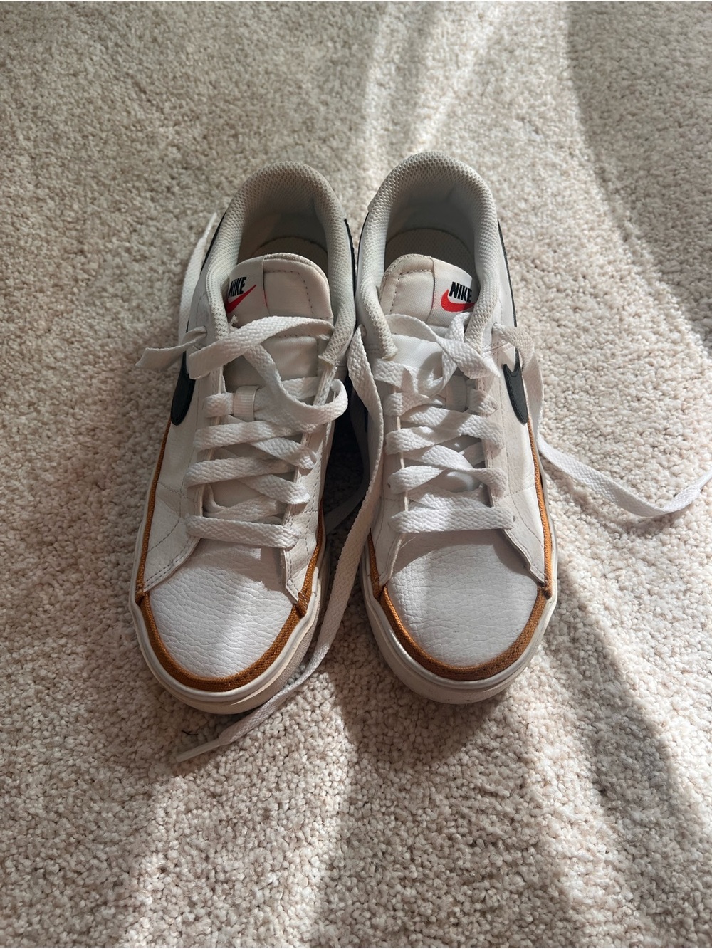 Nike women’s White Sneakers with Black Swoosh and Brown Trim
